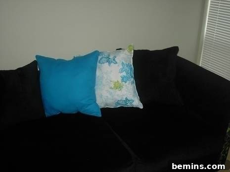 DIY Couch Makeover: An Upholstery Guide for Beginners 4 Blue and white cushions on the reupholstered couch