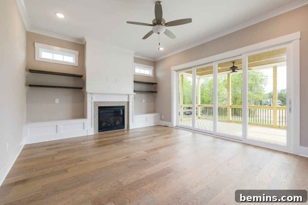 The Ultimate Spring Refresh: Your Comprehensive Cleaning Guide 3 Spacious living room with fireplace and ceiling fan overlooking veranda through glass doors.
