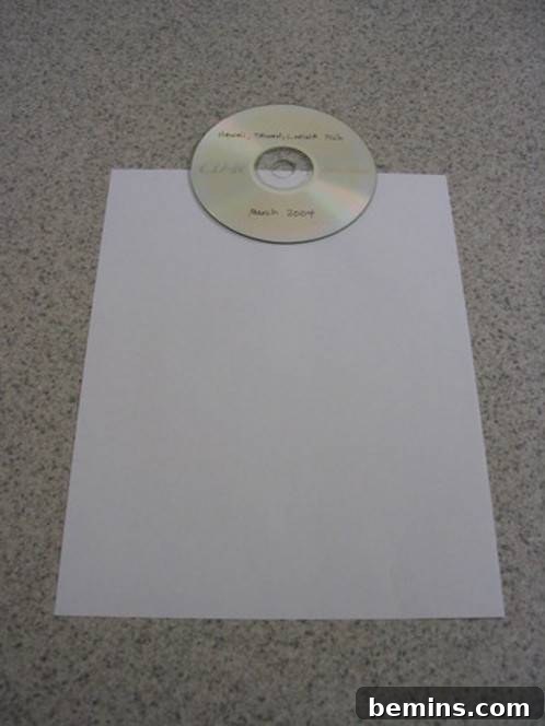 A CD positioned on a sheet of paper, ready for the first fold.