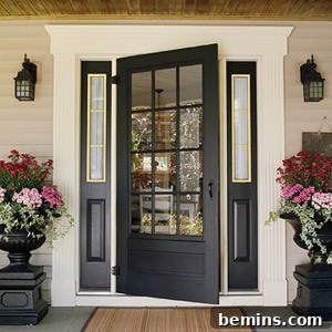 Elegant black front door with symmetrical flower arrangements, enhancing curb appeal.