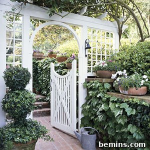 A welcoming white garden gate adds charm and enhances curb appeal.