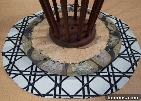 Positioning the new fabric on the stool