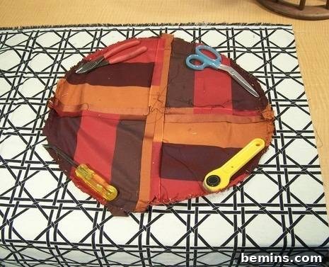 Laying the old fabric pattern on top of the new fabric
