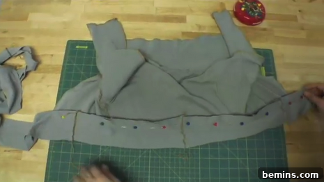 Pin the sash to the front of the shrug