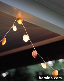Seashell String Lights: A string of clam lights hanging from a white beam.