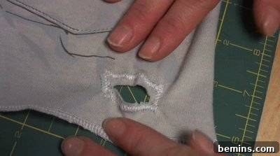 A square of fabric with a hole cut into it. Making Ties.