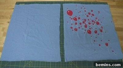 Red balloons are printed on a light blue material. Picnic Blanket DIY.