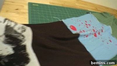 Red balloons are shown on a multicolored piece of material. Handmade Picnic Blanket.
