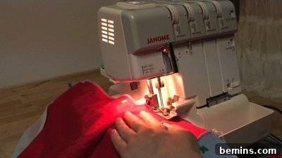 A person sewing a red piece of fabric. Sewing Machine Project.
