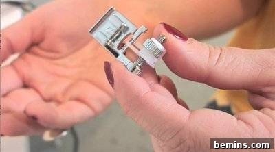 A hand holding a tiny electrical component.