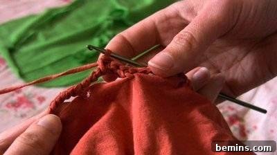 Person Crocheting with Red Yarn