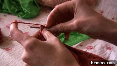 Person Crocheting Red Fabric