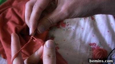 Woman Crocheting Neckline of Dress