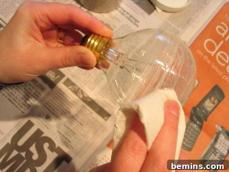 DIY Sanded Light Bulb 5 Clear caulk and sand is being used to create a sanded lightbulb for an interesting display.