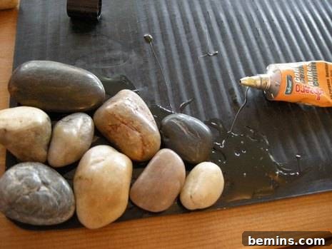 DIY pebble bath mat in progress with glue applied.