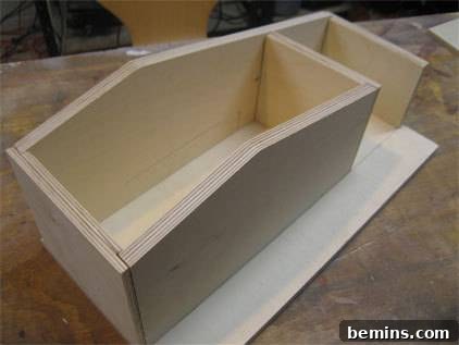A partially assembled wooden birdhouse, showcasing the progress of the project.