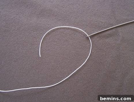 DIY Mod Upholstery: Faux Tufting Techniques 6 Threading the upholstery needle with twine