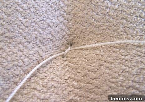 DIY Mod Upholstery: Faux Tufting Techniques 10 Pulling the twine snug and tying a knot