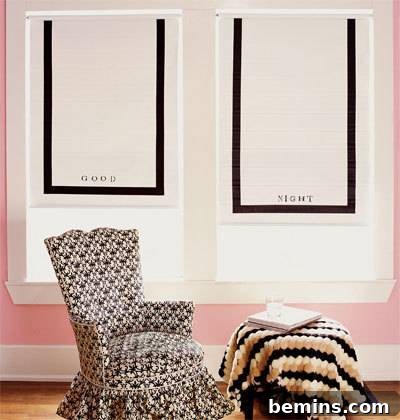 A grey patterned chair next to a table that has yellow patterned fabric on it. The nearby window shade could be painted to match the room's color scheme.