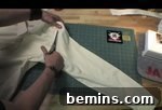 A tailor cutting the pant using scissors