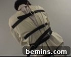A man is tied in a straight jacket.