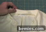 A person is working with a white shirt.