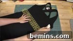 A black dress being designed on a table for a witch costume.