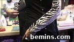 A person wearing a black shirt with zebra-striped sleeves, showcasing a potential fabric choice.