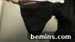 The side of a womans torso with her arm outspred wearing a flowing black sleeved dress, showcasing a finished costume.