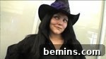 A woman in a black shirt and purple witch hat, showcasing the completed costume.
