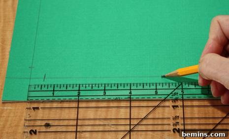 Marking quarter-length points on cardboard for pillow form