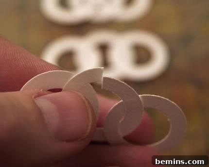 A close-up view of the delicate and intricate design of the paper garland, showcasing the alternating pattern of small white circles.