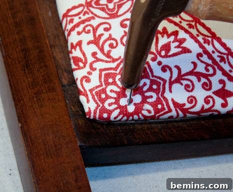 Tacking nail into the chair frame