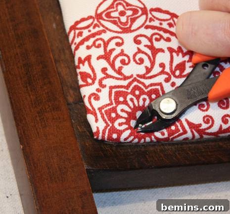 Gripping the nail with pliers