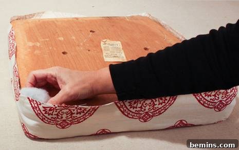Pulling fabric over seat