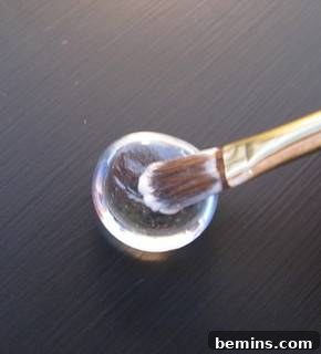 Applying Mod Podge to marbles