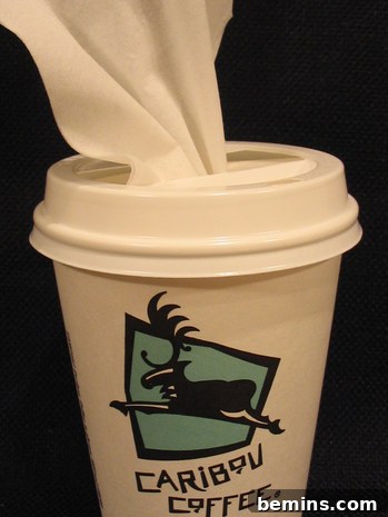 Crafty Coffee: DIY Tissue Dispenser 2 A white napkin pokes out from the lid of a Caribou Coffee cup.