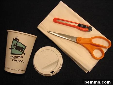 Crafty Coffee: DIY Tissue Dispenser 3 Scissors and another tool on a white napkin near a cup and its lid.