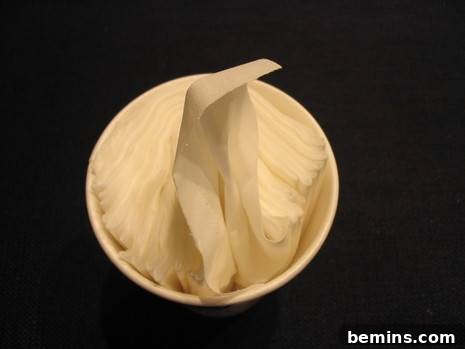 Coffee filters are arranged in a cup on a black surface.