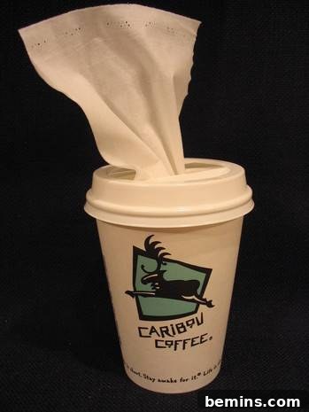 Crafty Coffee: DIY Tissue Dispenser 10 A cup with Caribou coffee on it has a tissue hanging out of the top.