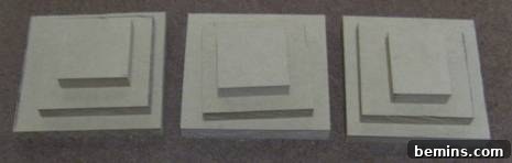 Three white squares with white squares on them and white squares on top of that.