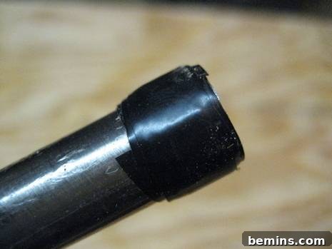 Black tape is on a silver pipe.