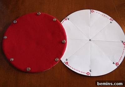 Close-up of two fabric circles, one reddish-brown and the other white, with snaps attached, ready to be assembled into a snap box.