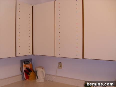 After: White cabinets are hanging bare.