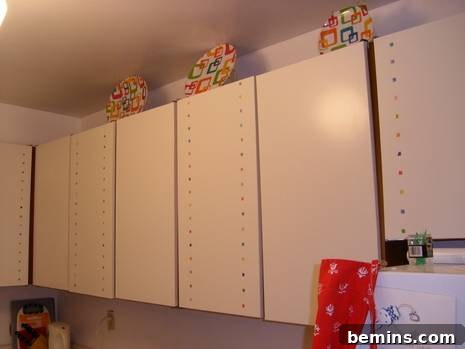 Finished kitchen with white cabinets and colorful stickers