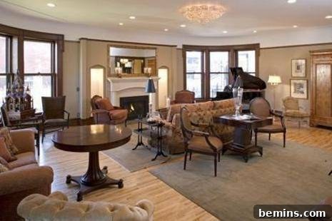 The Iconic Mary Tyler Moore House is On The Market 4 A spacious and inviting living room with a fireplace, comfortable seating, and elegant decor
