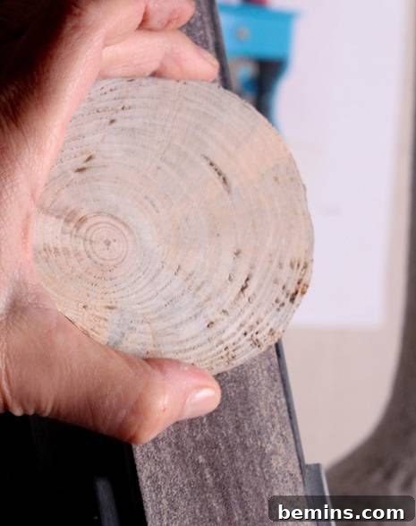 Rustic Branch Coasters 6 Sanding a wood slice coaster to achieve a smooth surface
