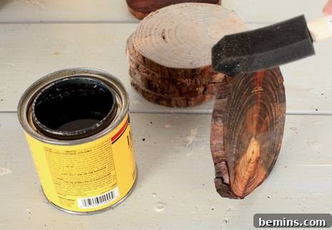 Rustic Branch Coasters 7 Applying natural wood stain to a tree limb coaster