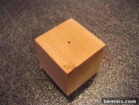 A wooden block with a hole drilled in the top