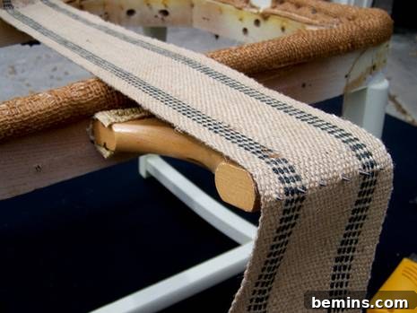 Using a web stretcher to tighten the jute webbing